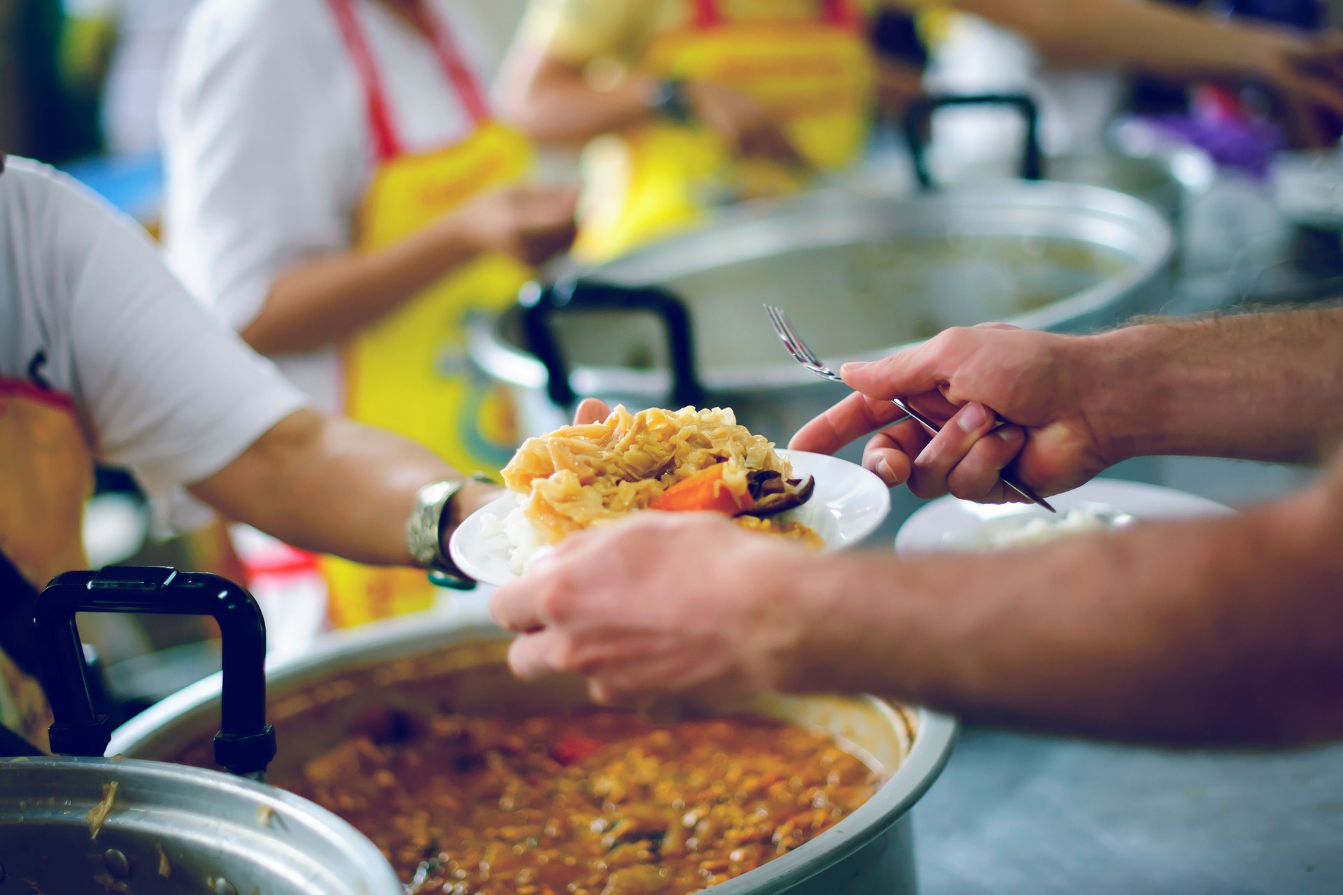Volunteers provide food for beggars: Concepts Feeding and help